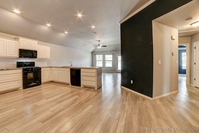 kitchen with kitchen peninsula, ceiling fan, black appliances, light hardwood / wood-style floors, and white cabinetry