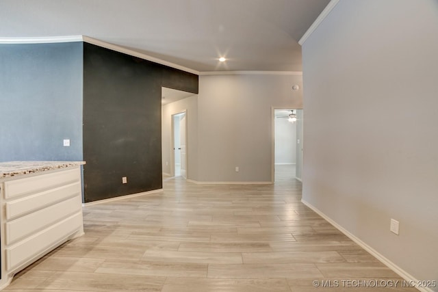 empty room featuring crown molding, light hardwood / wood-style flooring, and ceiling fan