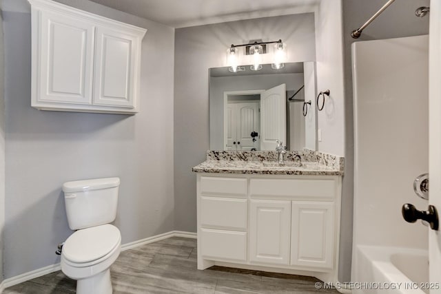 full bathroom featuring hardwood / wood-style floors, vanity, toilet, and washtub / shower combination