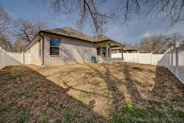 rear view of house with a yard