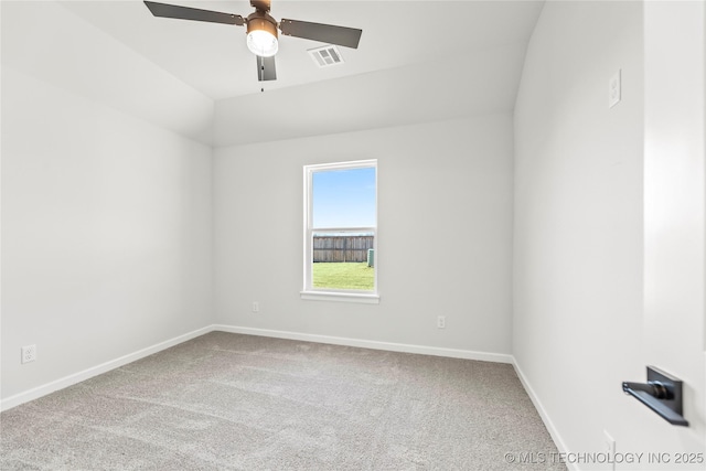 carpeted spare room with ceiling fan and lofted ceiling