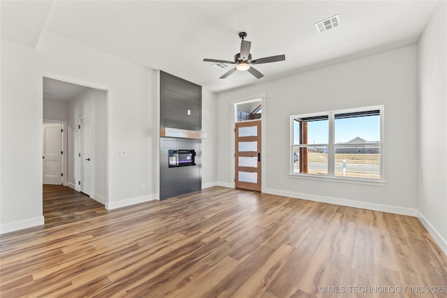 unfurnished living room featuring ceiling fan and light wood-type flooring