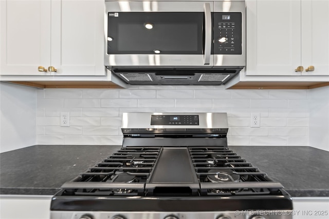 kitchen featuring decorative backsplash, white cabinetry, and appliances with stainless steel finishes