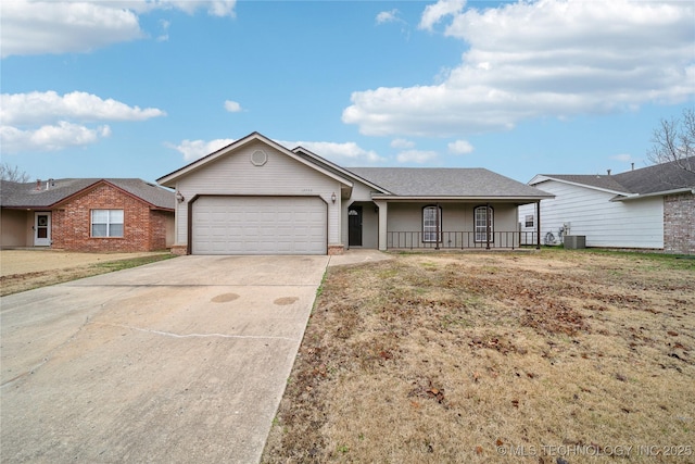 single story home with covered porch, central AC, and a garage