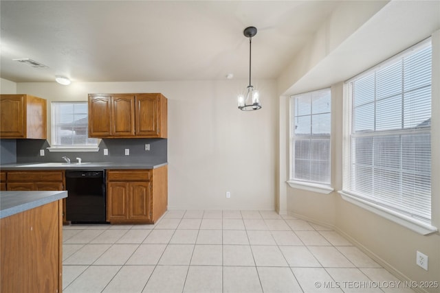 kitchen featuring pendant lighting, dishwasher, light tile patterned floors, tasteful backsplash, and a notable chandelier