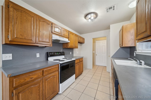 kitchen featuring light tile patterned floors, white range with electric cooktop, and sink