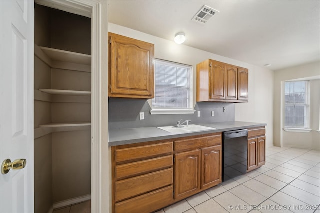 kitchen featuring dishwasher, light tile patterned flooring, a wealth of natural light, and sink