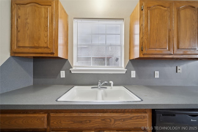 kitchen featuring backsplash, black dishwasher, and sink