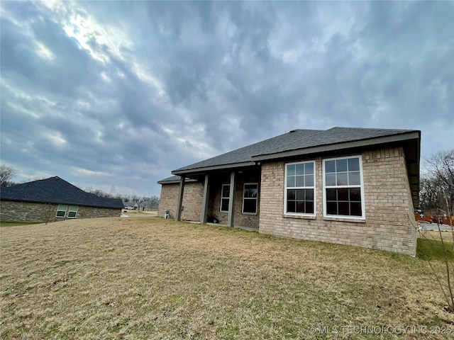 rear view of house featuring a lawn