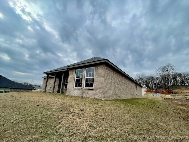 view of side of property with a yard