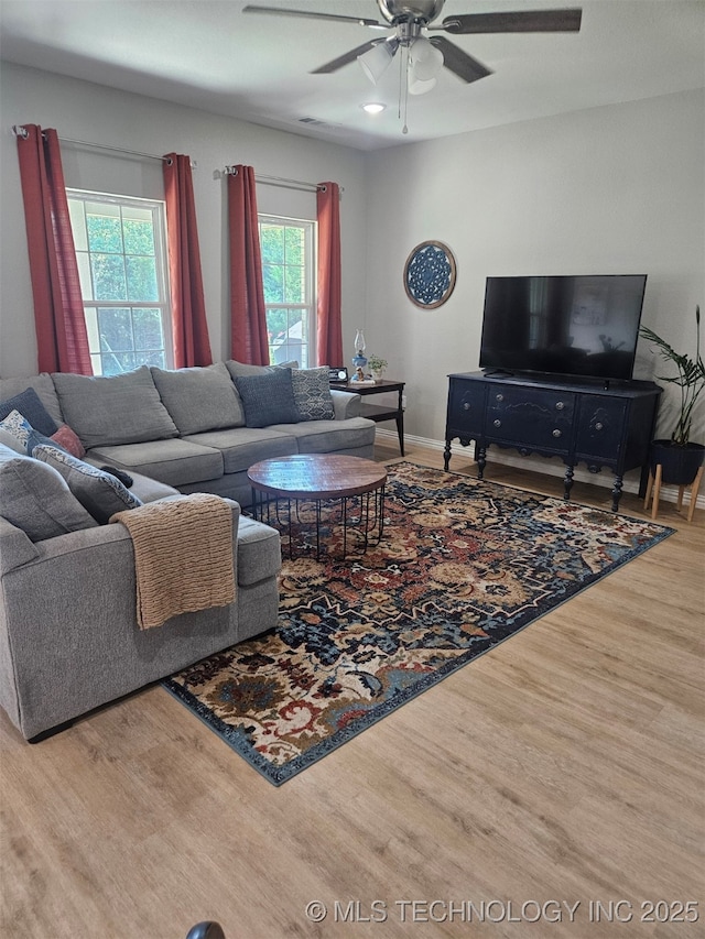 living room featuring hardwood / wood-style flooring and ceiling fan