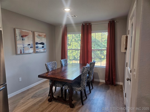 dining space featuring wood-type flooring