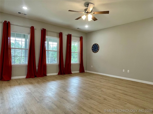 spare room with light wood-type flooring and ceiling fan