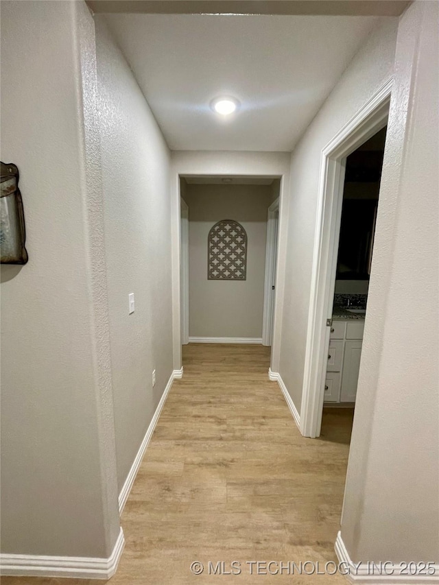 hall with light hardwood / wood-style flooring