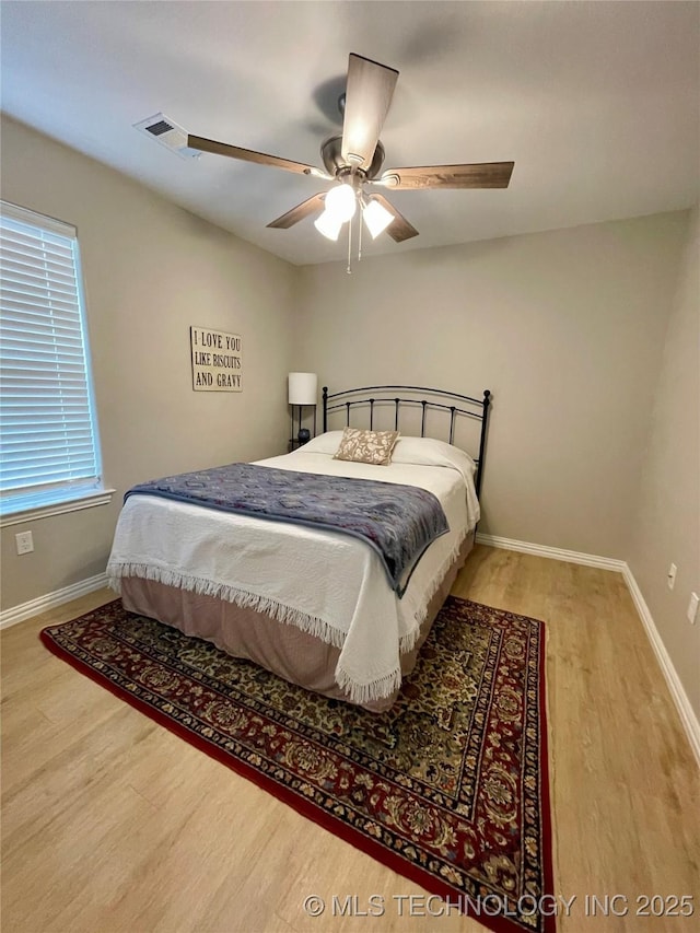 bedroom featuring hardwood / wood-style floors and ceiling fan