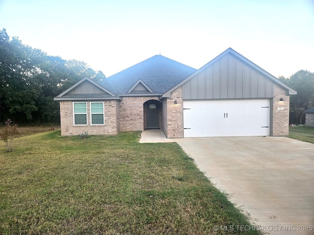 view of front of property featuring a garage and a front lawn