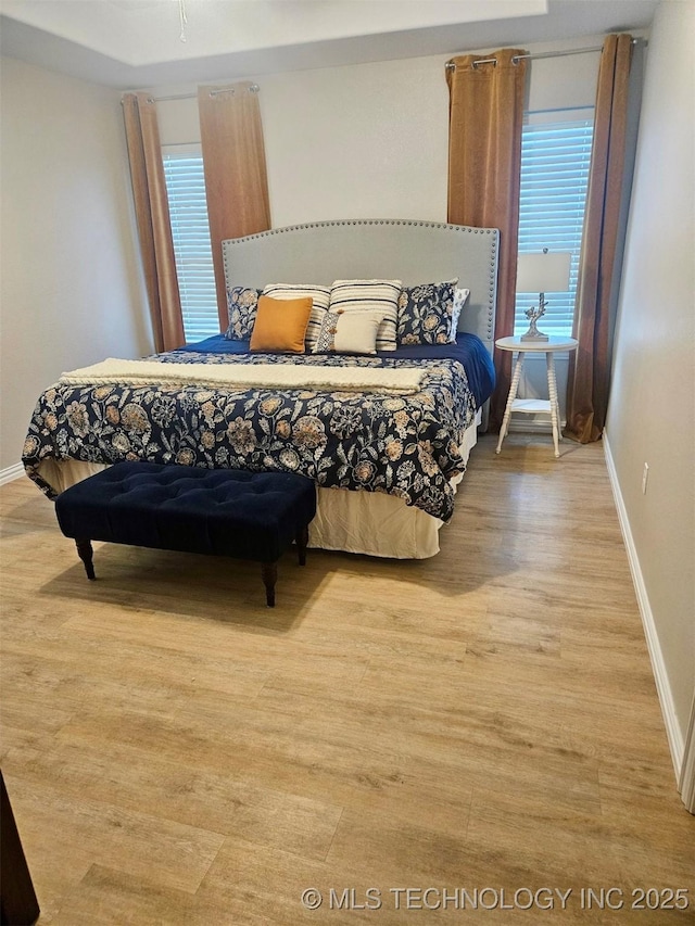 bedroom featuring light wood-type flooring and multiple windows