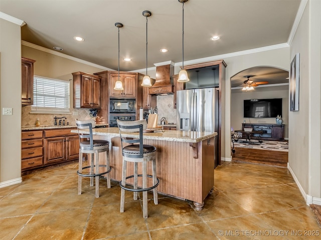 kitchen featuring custom exhaust hood, a center island, decorative backsplash, and black microwave