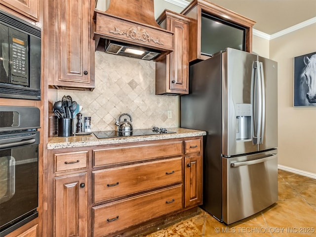 kitchen featuring premium range hood, black appliances, ornamental molding, tasteful backsplash, and light stone counters