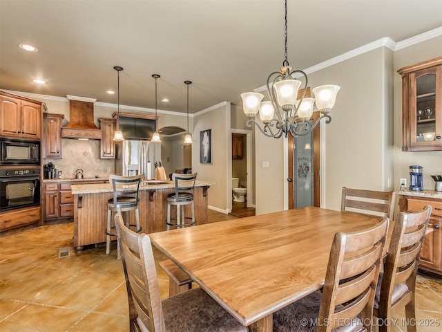 dining room with a notable chandelier and crown molding