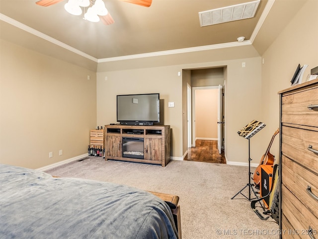 carpeted bedroom featuring a fireplace, ceiling fan, and crown molding