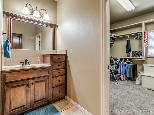 bathroom featuring tile patterned flooring and vanity