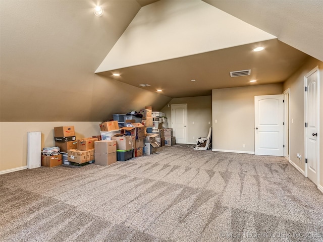 bonus room with carpet flooring and vaulted ceiling