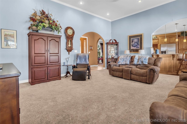 carpeted living room with a high ceiling and ornamental molding