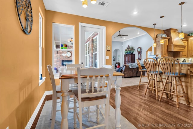 dining area with hardwood / wood-style flooring and ceiling fan