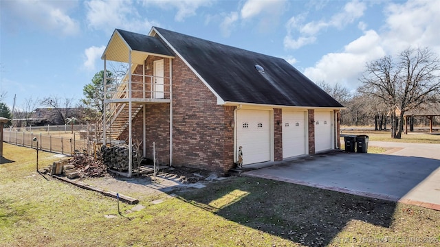 view of side of property featuring a yard and a garage