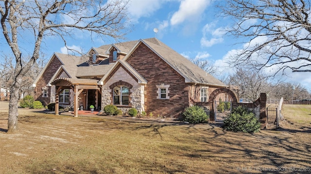 english style home with a front lawn