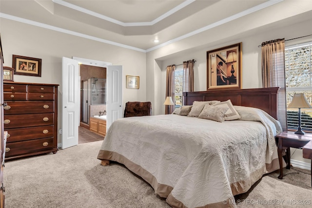 bedroom with a tray ceiling, connected bathroom, light carpet, and multiple windows