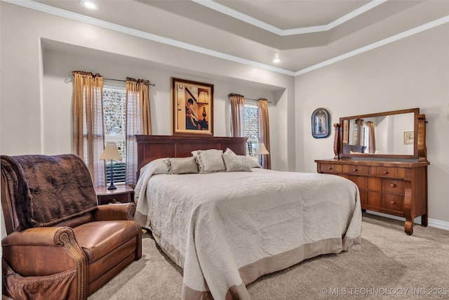 carpeted bedroom featuring a raised ceiling and crown molding