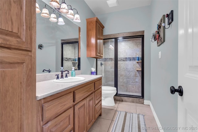 bathroom with toilet, vanity, tile patterned floors, and walk in shower