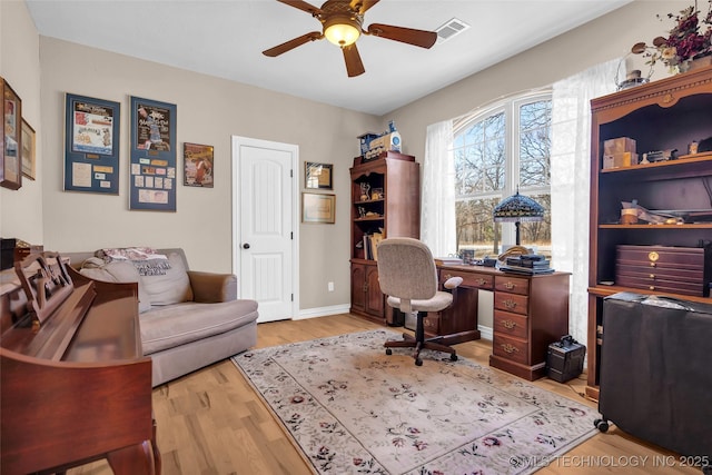 home office featuring ceiling fan and light hardwood / wood-style flooring