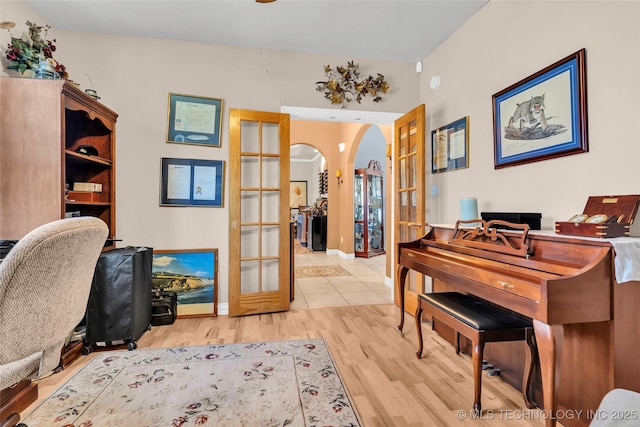 office space with french doors and light wood-type flooring