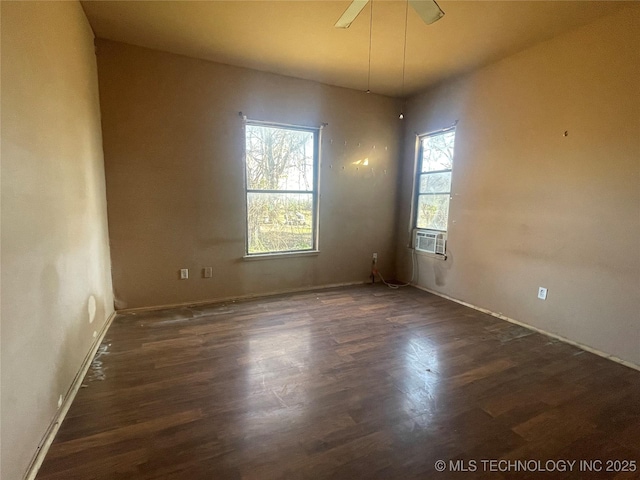 unfurnished room featuring ceiling fan, cooling unit, and dark wood-type flooring