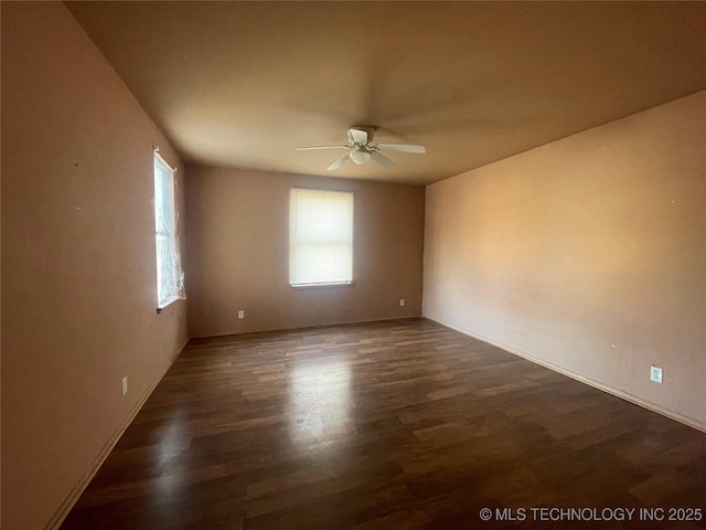 empty room featuring dark hardwood / wood-style floors and ceiling fan