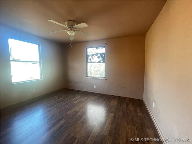 empty room featuring dark hardwood / wood-style floors and ceiling fan