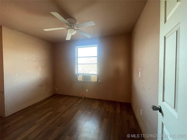 spare room featuring ceiling fan, dark hardwood / wood-style flooring, and cooling unit