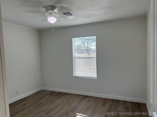 empty room featuring ceiling fan, dark hardwood / wood-style flooring, and ornamental molding