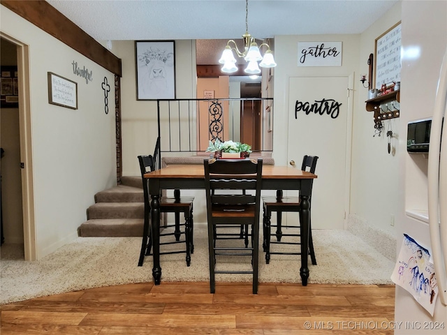 dining room featuring a chandelier and hardwood / wood-style floors