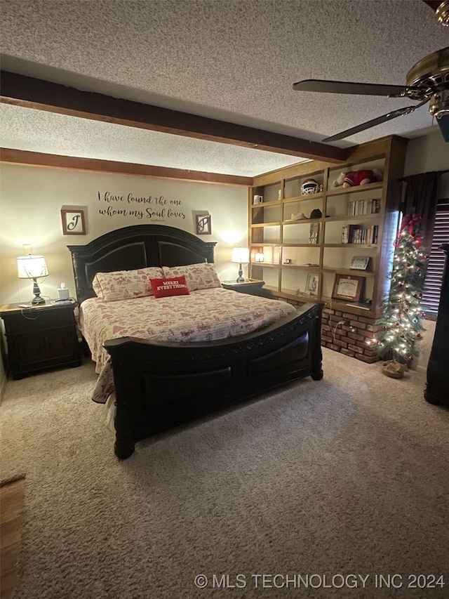 bedroom with beamed ceiling, ceiling fan, carpet flooring, and a textured ceiling