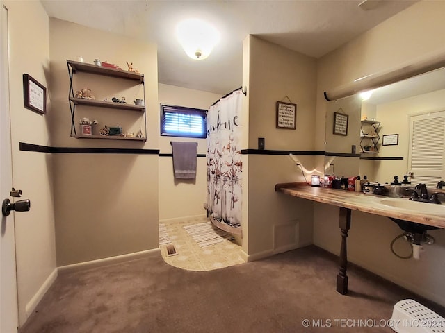 bathroom with a shower with shower curtain and sink