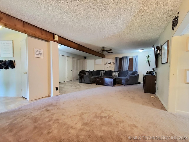 unfurnished living room with a textured ceiling, light colored carpet, and ceiling fan