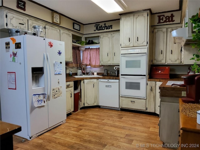 kitchen featuring sink, wood counters, light hardwood / wood-style floors, white appliances, and exhaust hood