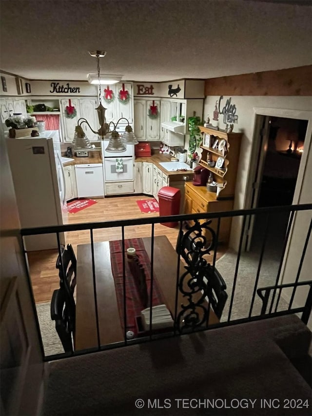 kitchen featuring white refrigerator and a textured ceiling