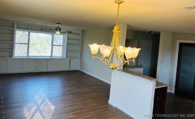 unfurnished dining area with a chandelier and dark hardwood / wood-style floors