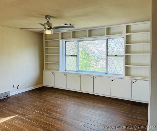 spare room featuring dark hardwood / wood-style flooring, ceiling fan, and built in features