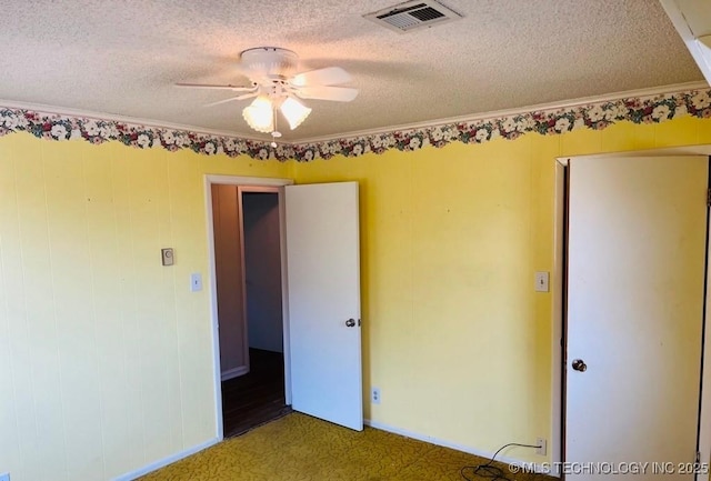 unfurnished bedroom with a textured ceiling, ceiling fan, and crown molding